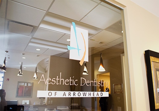 Aesthetic Dentistry of Arrowhead dentist office door logo