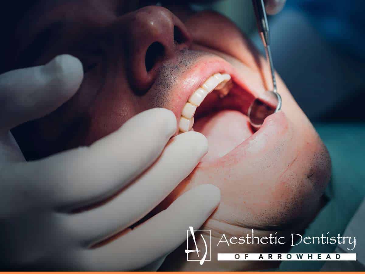 Dentist evaluating causes of sensitive teeth